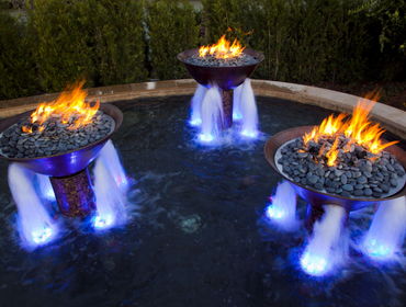 A beautifully lit water fountain featuring vibrant blue lights